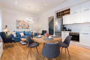 a living room with a blue couch and a table at Arieni Sea View House in Corfu