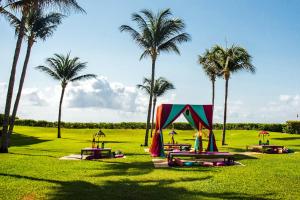
a picnic table with umbrellas on top of it at Dreams Jade Resort & Spa - All Inclusive in Puerto Morelos
