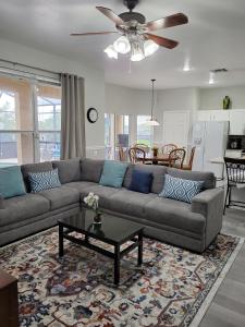 a living room with a couch and a table at Newly renovated Windsor Hills residential home in Orlando