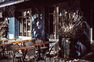 a group of tables and chairs in front of a building at Babel Belleville in Paris