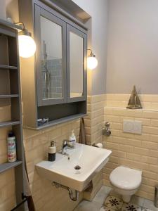 a bathroom with a sink and a toilet at Schöne Ferienwohnung in der City Königswohnung Jun in Kiel