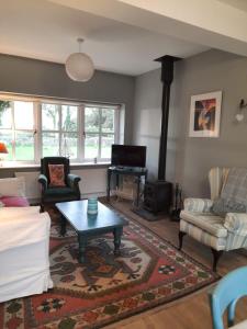 a living room with a couch and a coffee table at Croagh Patrick Lodge Apartment in Westport