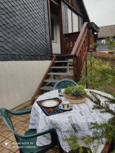 a table and chairs on a patio with a house at Gasthaus Piesau - Thüringer Wald - Rennsteig in Piesau