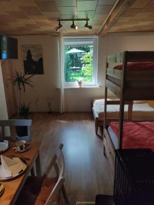 a room with two bunk beds and a table and a window at Gasthaus Piesau - Thüringer Wald - Rennsteig in Piesau