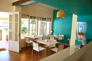 a dining room with two tables and chairs and a fishtank at Nova Posada in Colonia del Sacramento