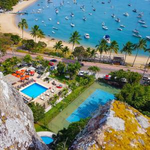 an aerial view of a resort with a beach and boats at Hotel Itapemar - Ilhabela in Ilhabela