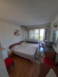 a bedroom with a bed and a table and chairs at Villa Trakia in Golden Sands +106 photos