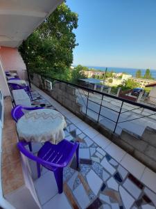 a balcony with purple chairs and a table and a view at Villa Trakia in Golden Sands
