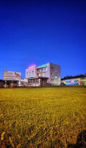 a large building with a field in front of it at Vu-Dent Apartments in Gevgelija