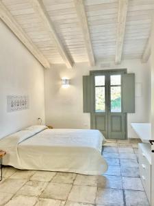 a bedroom with a large bed and a window at Tenuta Paltusa in Calangianus