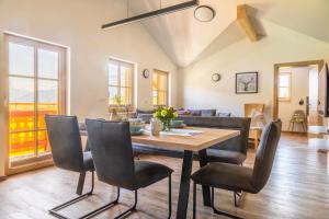 a living room with a table and chairs and a couch at Ferienwohnung Kracherbauer in Saalfelden am Steinernen Meer