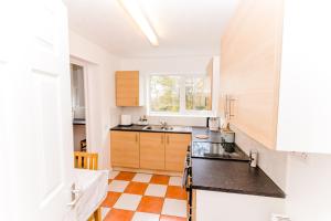 a kitchen with a sink and a counter top at Cosy City Centre Apartment With Parking in Norwich