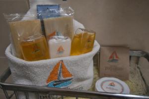 a basket with candles and other items on a shelf at Hotel Portonovo Plaza Guadalajara in Guadalajara