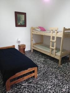 a bedroom with two bunk beds and a ladder at Family Place II in Luján