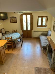 a living room with a table and a couch at Casa Encuentra, en el Pirineo al lado de Ainsa in El Pueyo de Araguás +61 photos