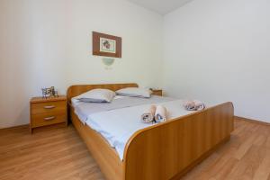 Postel nebo postele na pokoji v ubytování Apartments Anica