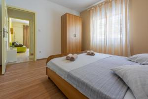 Postel nebo postele na pokoji v ubytování Apartments Anica