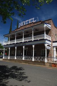a large white building with a clock on the side of it at Jamestown Hotel in Jamestown