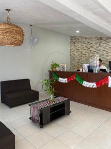 a lobby with a counter with a christmas ribbon at Hotel Balxibá alberca y estacionamiento in Playa del Carmen +97 photos