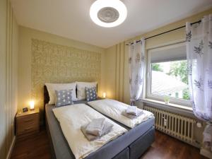 a bedroom with a large bed and a window at Fewo Steingrotte (inkl. MeineCard+) in Willingen