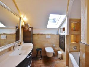 a bathroom with a sink and a toilet and a mirror at Fewo Steingrotte (inkl. MeineCard+) in Willingen +32 photos