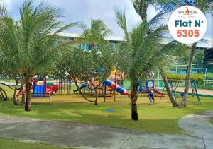 um parque com um parque infantil com palmeiras e uma placa em Resort Ancorar Porto de Galinhas Flat 5305 em Porto de Galinhas