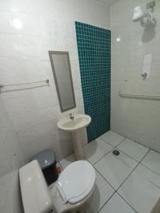 a bathroom with a toilet and a sink and a mirror at Tropical Mooca in Sao Paulo +37 photos