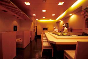two men standing in a restaurant with a sink at ホテルルポール麹町 in Tokyo