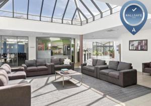 a living room with couches and a glass ceiling at ibis Styles Canberra Eagle Hawk in Canberra