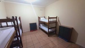 a small room with two bunk beds in a room at Tropical Mooca in Sao Paulo