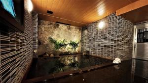 a bathroom with a tub with plants in it at Hotel Route-Inn Hakata Ekimae -Hakataguchi- in Fukuoka