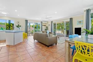 a living room with a couch and a table at Peace within the palms, Castaways Beach in Sunrise Beach