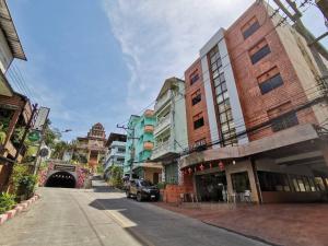 an empty street in a city with buildings at Betong Hello Hotel in Betong