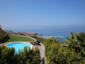 a villa with a swimming pool and a view of the ocean at Belvilla by OYO Bottone in Parghelia
