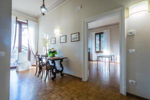 a living room with a table and a dining room at Hortensia Garden in Macerata