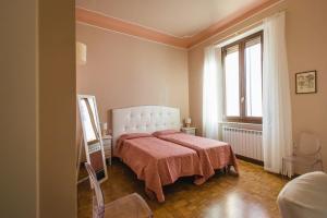 een slaapkamer met een bed en een groot raam bij Hortensia Garden in Macerata