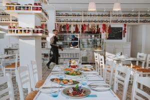 a dining room with a table with plates of food at Ivi Mare - Designed for Adults by Louis Hotels in Paphos