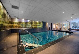 a large swimming pool in a building with a swimming pool at Boshotel - Vlodrop, Roermond in Vlodrop