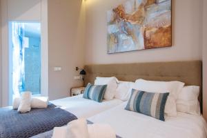 a hotel room with a bed and a painting on the wall at Maestranza Boutique in Seville