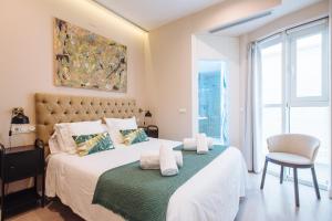 A bed or beds in a room at Maestranza Boutique