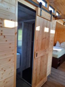 a door in a tiny house with a bedroom at Eisenbahnromantik im Urlaub in Heinsdorfergrund