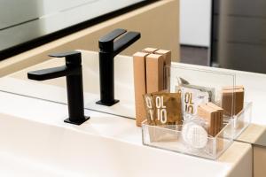 a counter with a black faucet and some boxes at PALAZZO CIOTTI in Ascoli Piceno