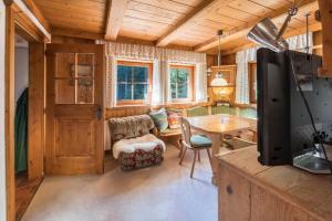 a living room with a tv and a table at Polle Hütte - Eg in Königsleiten