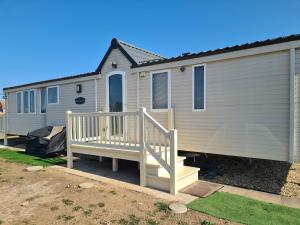 a mobile home with a porch and a house at 6 Berth The Chase Ingoldmells Concept in Ingoldmells