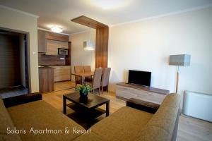 a living room with a couch and a table at Solaris Apartman&Resort in Cserkeszőlő