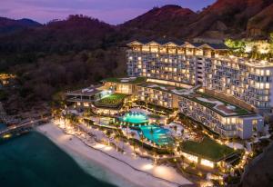 an aerial view of a resort on the beach at night at AYANA Komodo Waecicu Beach in Labuan Bajo