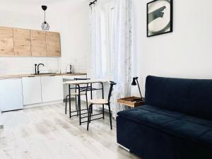 a living room with a couch and a kitchen at Gościniec i Restauracja Salton in Bochnia