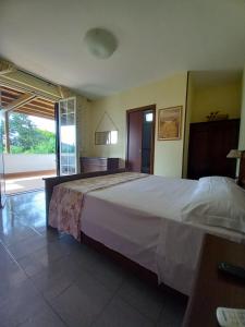 a bedroom with a large bed in a room at Il Grifo in Sabaudia