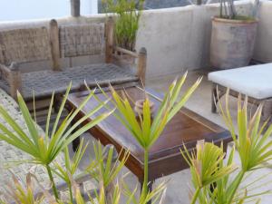 a patio with a table and chairs and plants at Riad Shambala in Marrakesh