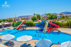 a large swimming pool with a water slide at a water park at Tivoli Hotel Aqua Park in Sharm El Sheikh